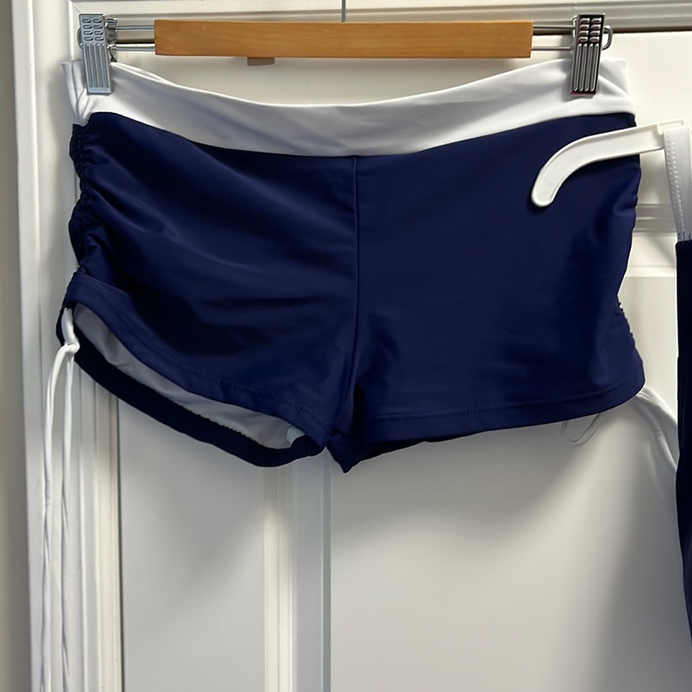 White and blue boy short swim suit. Size Large. Bottoms have side tie detail.